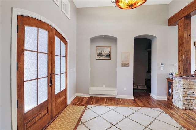 foyer featuring hardwood / wood-style floors and french doors