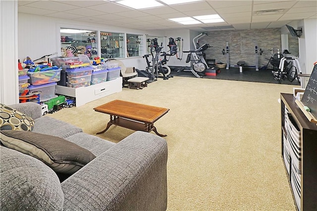 exercise room featuring carpet flooring and a drop ceiling