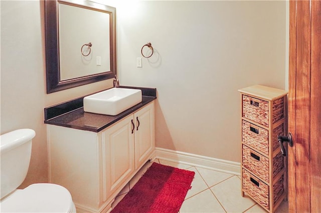 bathroom featuring tile patterned floors, vanity, and toilet