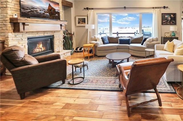 living room with a fireplace and wood-type flooring