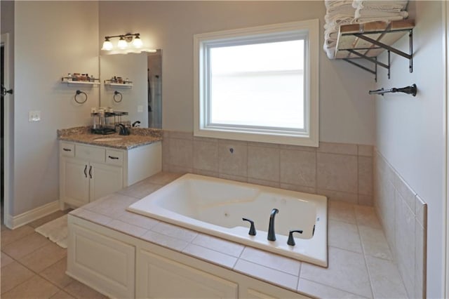 bathroom featuring vanity, tile patterned flooring, and a relaxing tiled tub