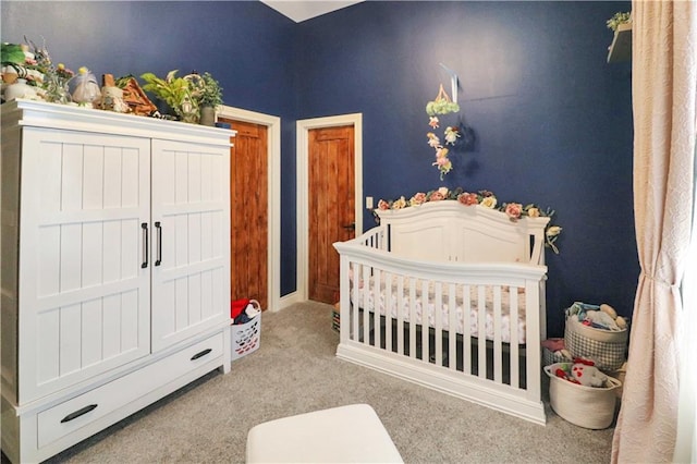 carpeted bedroom with a nursery area