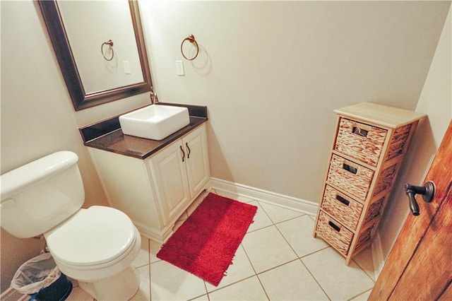 bathroom featuring tile patterned floors, vanity, and toilet