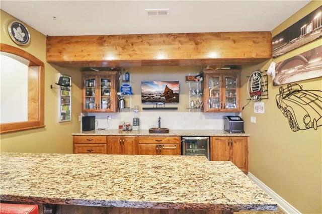 bar featuring sink and beverage cooler