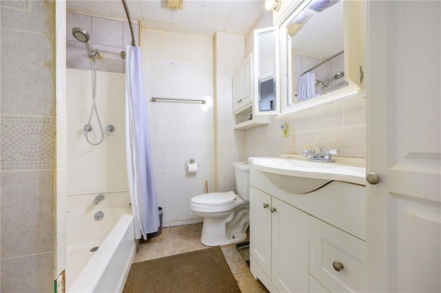 full bathroom featuring tile patterned floors, vanity, tile walls, and shower / tub combo with curtain