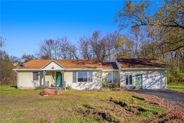 ranch-style home with a front lawn and a garage