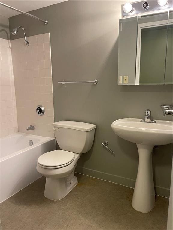 full bathroom featuring toilet, tiled shower / bath, and sink