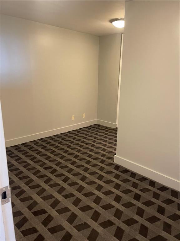 empty room with dark carpet