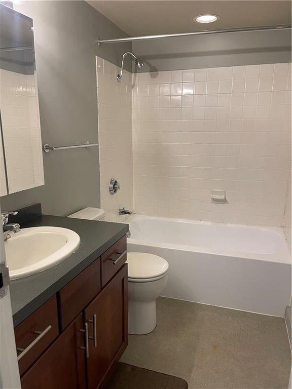 full bathroom with tiled shower / bath, vanity, and toilet