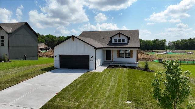 view of front of home featuring a front yard and a garage