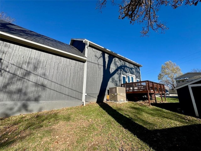 back of house with a lawn and a wooden deck