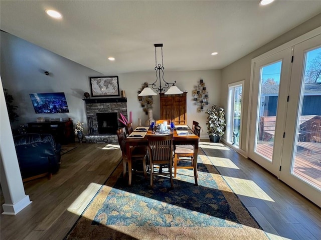 dining room featuring a fireplace and dark wood-type flooring