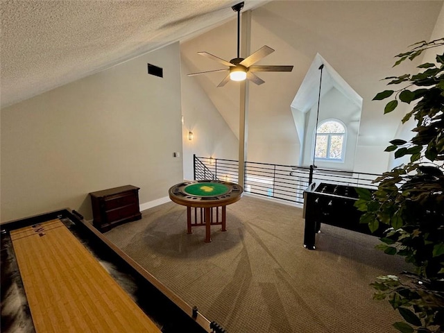 playroom with carpet flooring, ceiling fan, high vaulted ceiling, and a textured ceiling