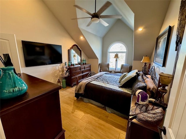 bedroom with ceiling fan, light hardwood / wood-style floors, and high vaulted ceiling