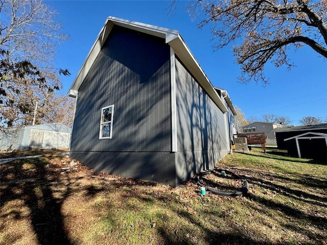 view of side of home featuring a lawn