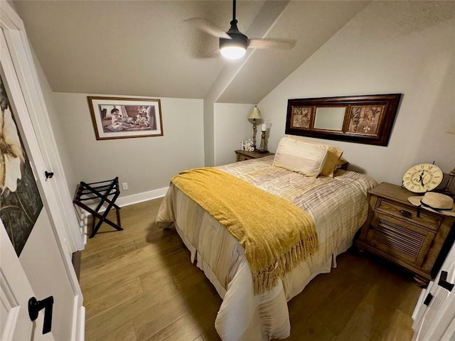 bedroom featuring vaulted ceiling, ceiling fan, and light wood-type flooring