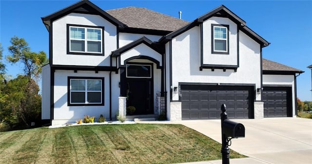 view of front facade with a garage and a front lawn