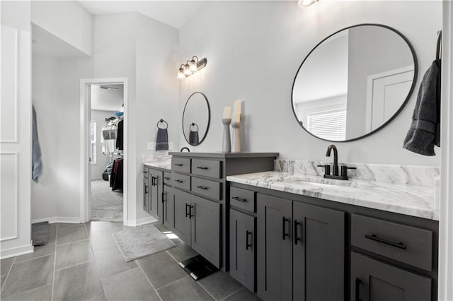 bathroom with tile patterned flooring, vanity, and a healthy amount of sunlight