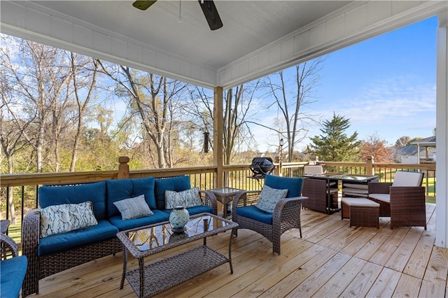 wooden terrace with outdoor lounge area and ceiling fan