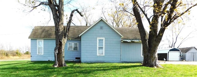 view of home's exterior with a lawn and a storage shed