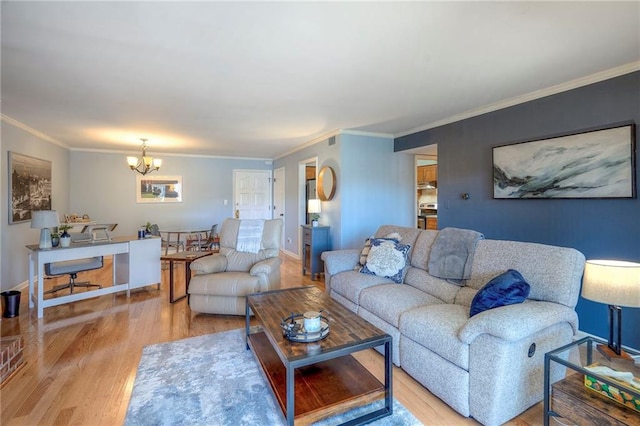 living room featuring ornamental molding, light hardwood / wood-style floors, and a notable chandelier