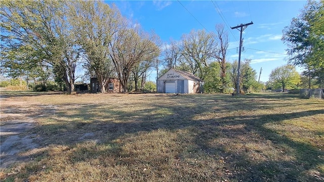 207 E 4th, Longton, KS 67352 - view of grassy yard featuring an outbuilding and a detached garage