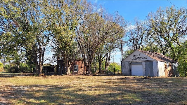 207 E 4th, Longton, KS 67352 - view of yard featuring an outdoor structure and a garage