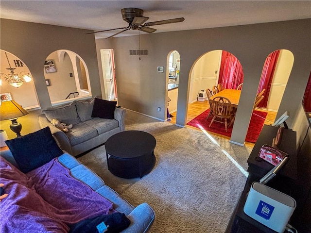 carpeted living room with ceiling fan