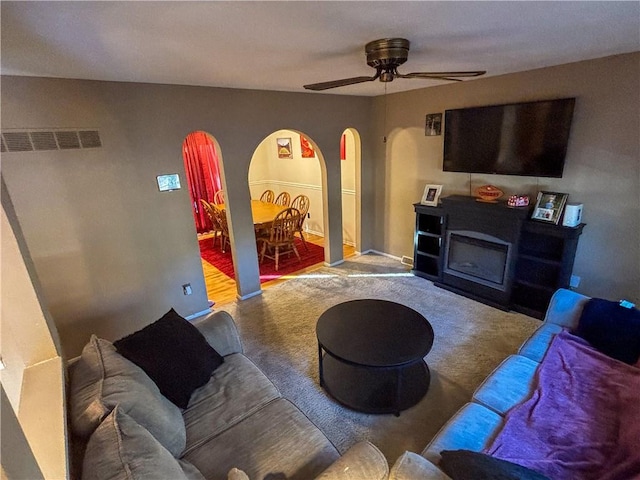 living room featuring carpet and ceiling fan