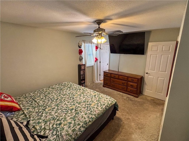 bedroom with carpet flooring, ceiling fan, and a textured ceiling