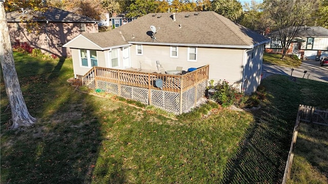 back of house with a lawn and a wooden deck