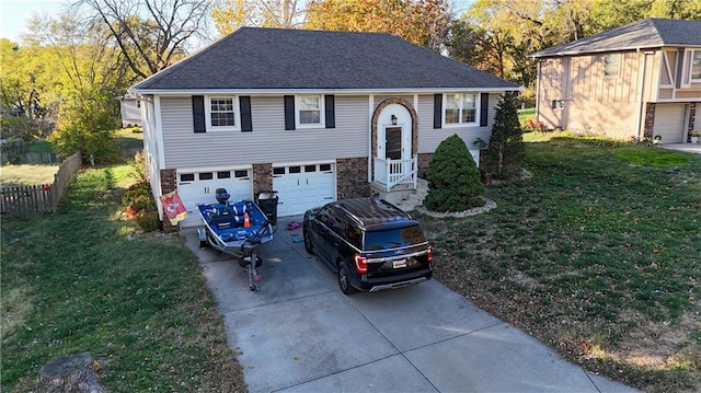 raised ranch with a garage and a front lawn