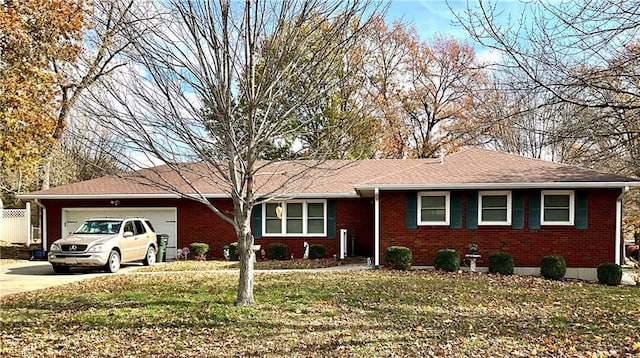 ranch-style home featuring a garage and a front yard