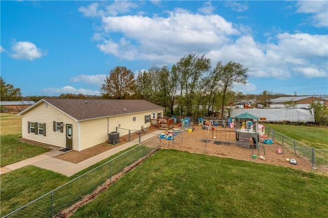 back of property featuring a yard, a playground, and cooling unit