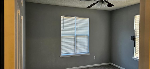 unfurnished room featuring carpet flooring, ceiling fan, and a textured ceiling