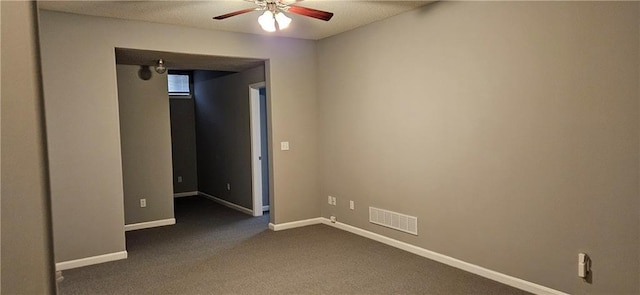 unfurnished bedroom featuring ceiling fan and dark carpet