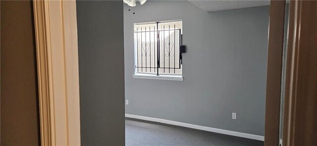 spare room with a textured ceiling, ceiling fan, and a healthy amount of sunlight