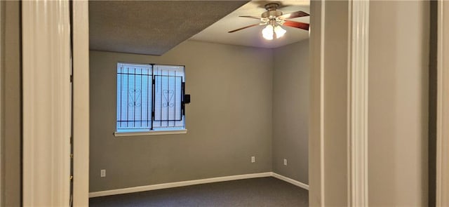 empty room with carpet flooring and ceiling fan