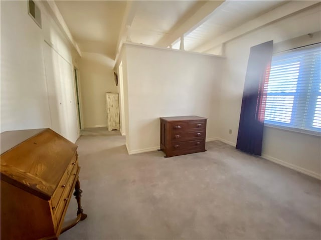 interior space featuring light carpet and beamed ceiling