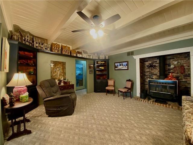 interior space with ceiling fan, beam ceiling, and carpet floors