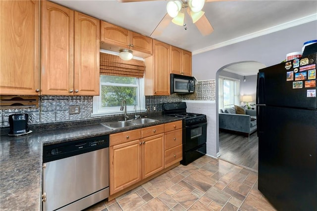 kitchen with black appliances, decorative backsplash, sink, and a wealth of natural light