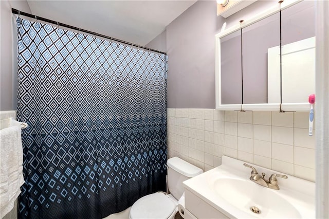 bathroom with a shower with shower curtain, vanity, toilet, and tile walls