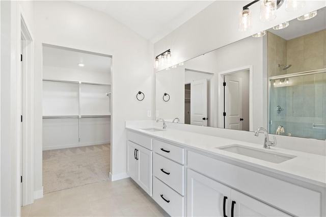 bathroom featuring vaulted ceiling, tile patterned flooring, a shower with door, and vanity