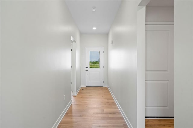 corridor with light hardwood / wood-style flooring