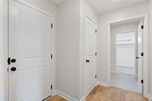 hallway with light hardwood / wood-style floors