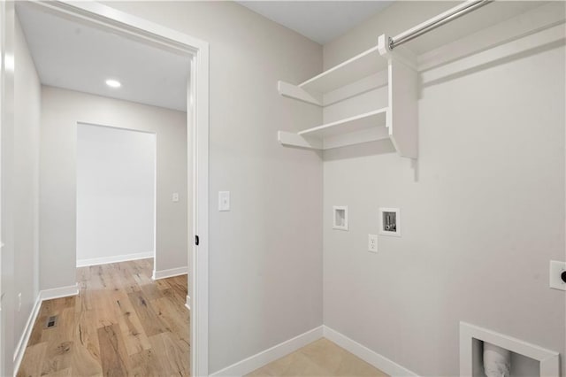 laundry room featuring washer hookup, light wood-type flooring, and hookup for an electric dryer