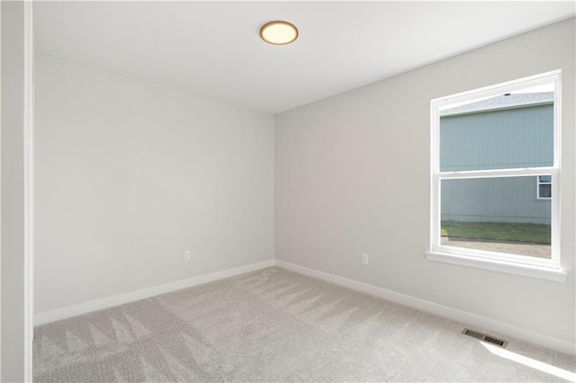 unfurnished room featuring light colored carpet