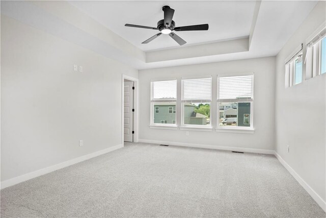 1933 SW Merryman Dr, Lees Summit, MO 64082 - carpeted spare room with baseboards, ceiling fan, and a tray ceiling