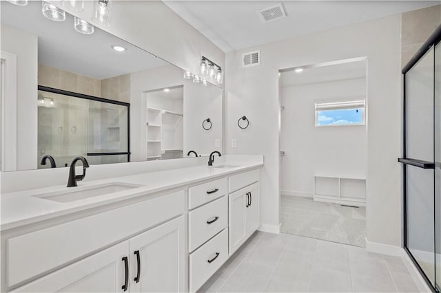 1933 SW Merryman Dr, Lees Summit, MO 64082 - bathroom with double vanity, a stall shower, baseboards, tile patterned floors, and recessed lighting