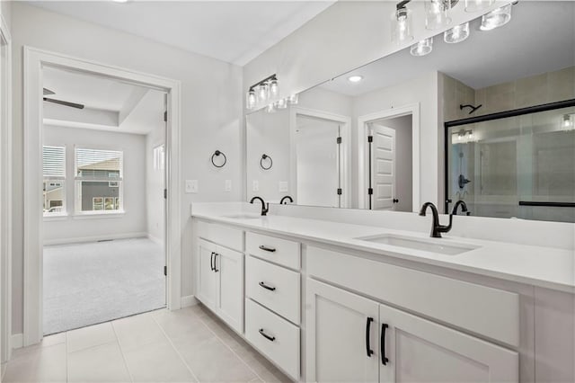 1933 SW Merryman Dr, Lees Summit, MO 64082 - full bathroom with double vanity, a shower stall, baseboards, and tile patterned floors